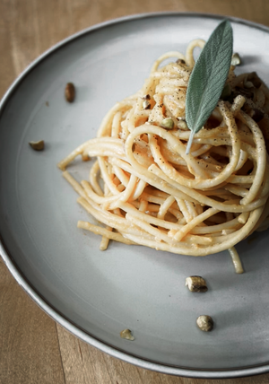 Pumpkin pasta on a plate with garnish