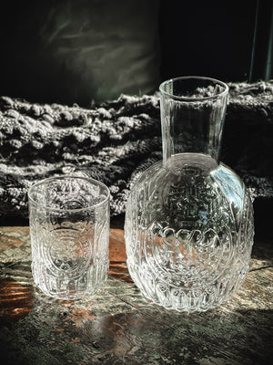 Anya Nesting Beside Carafe