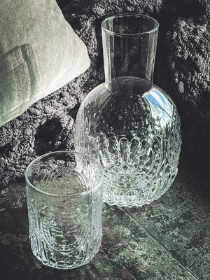 Anya Nesting Beside Carafe