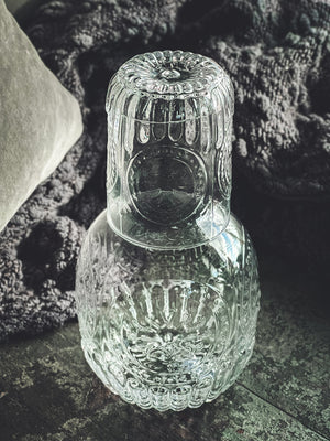 Anya Nesting Beside Carafe