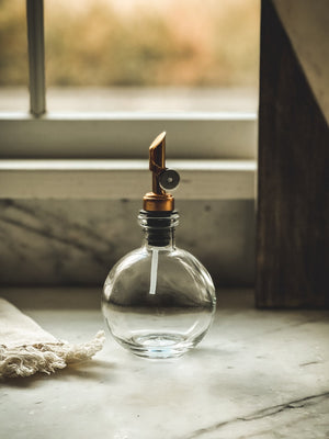 Apothecary Round Olive Oil/ Vinegar Dispenser on marble counter